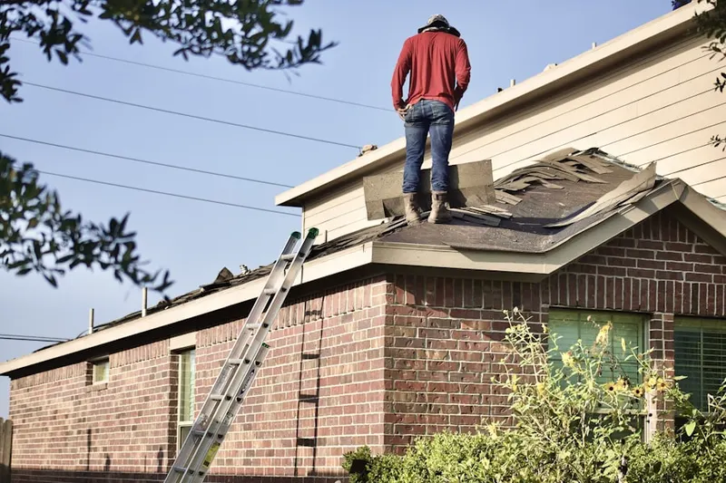 Professional roofer working on a residential roof in Racine